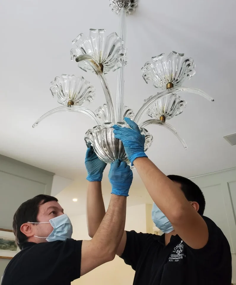 londono brothers working on chandelier