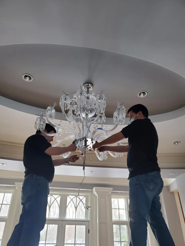 londono brothers working on chandelier install