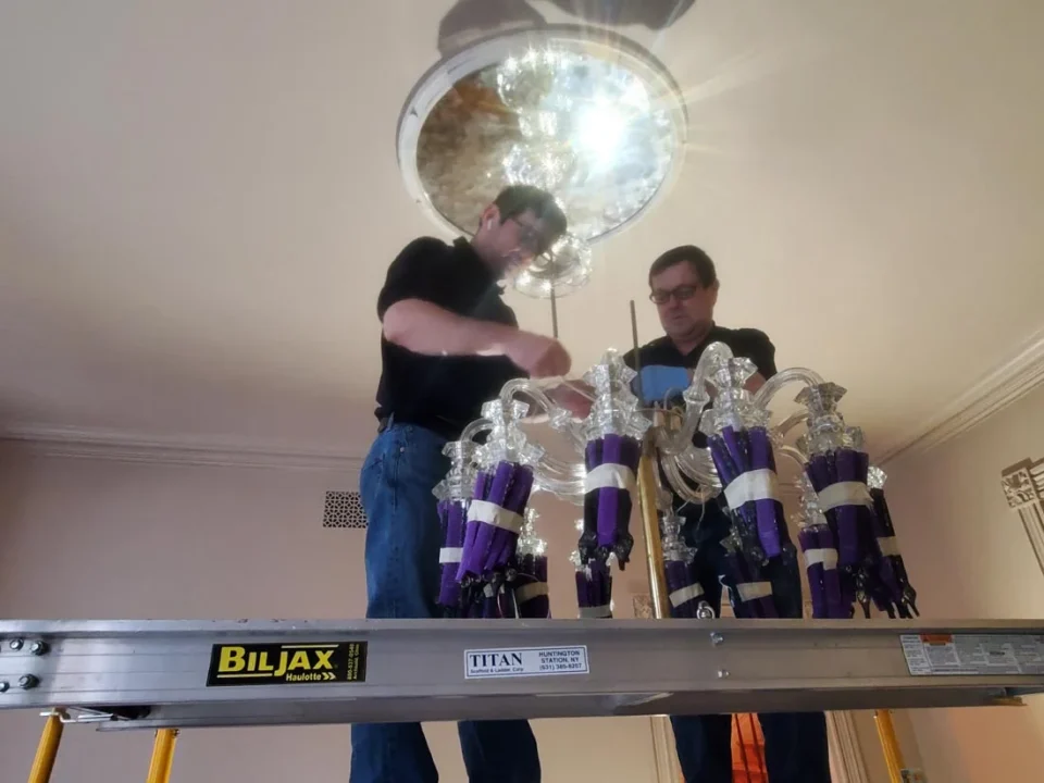 londono brothers working on chandelier