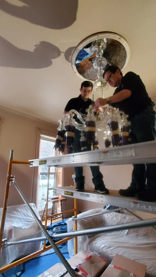 londono brothers working on chandelier